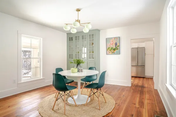 a view of a dining room with furniture wooden floor and chandelier