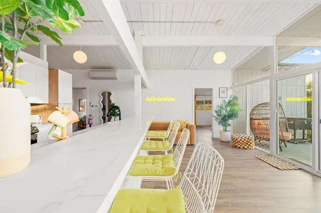 a living room with dining table and wooden floor