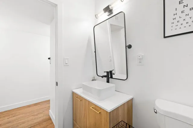 a bedroom with a bed a couch and dresser