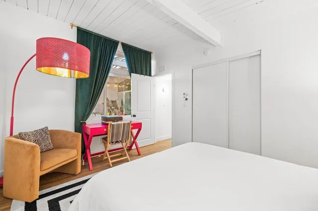 a bedroom with furniture and a window