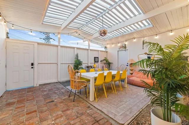 a dining room with chairs and wooden floor