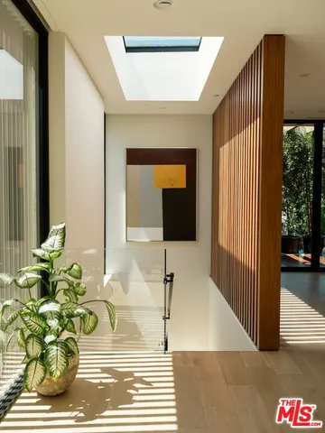 a vase of flowers sitting on a table next to a window