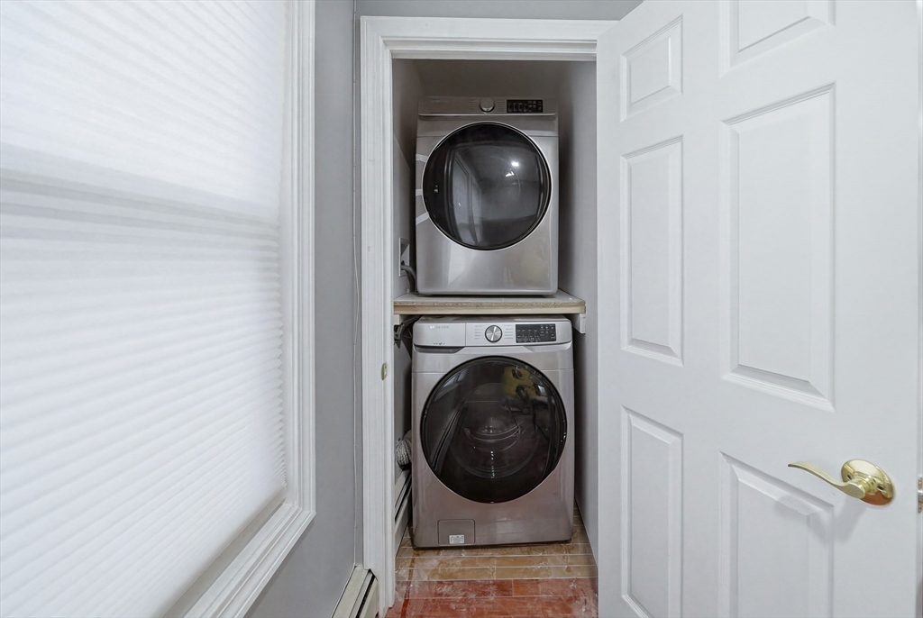 39 Hawthorne Street, Unit 39 Boston, MA 02119 - Photo 14 of 33 a view of a hallway with washer and dryer
