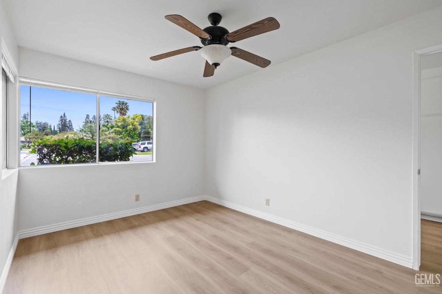 Undisclosed Address Bakersfield, CA 93306 - Photo 11 of 46 an empty room with wooden floor and windows