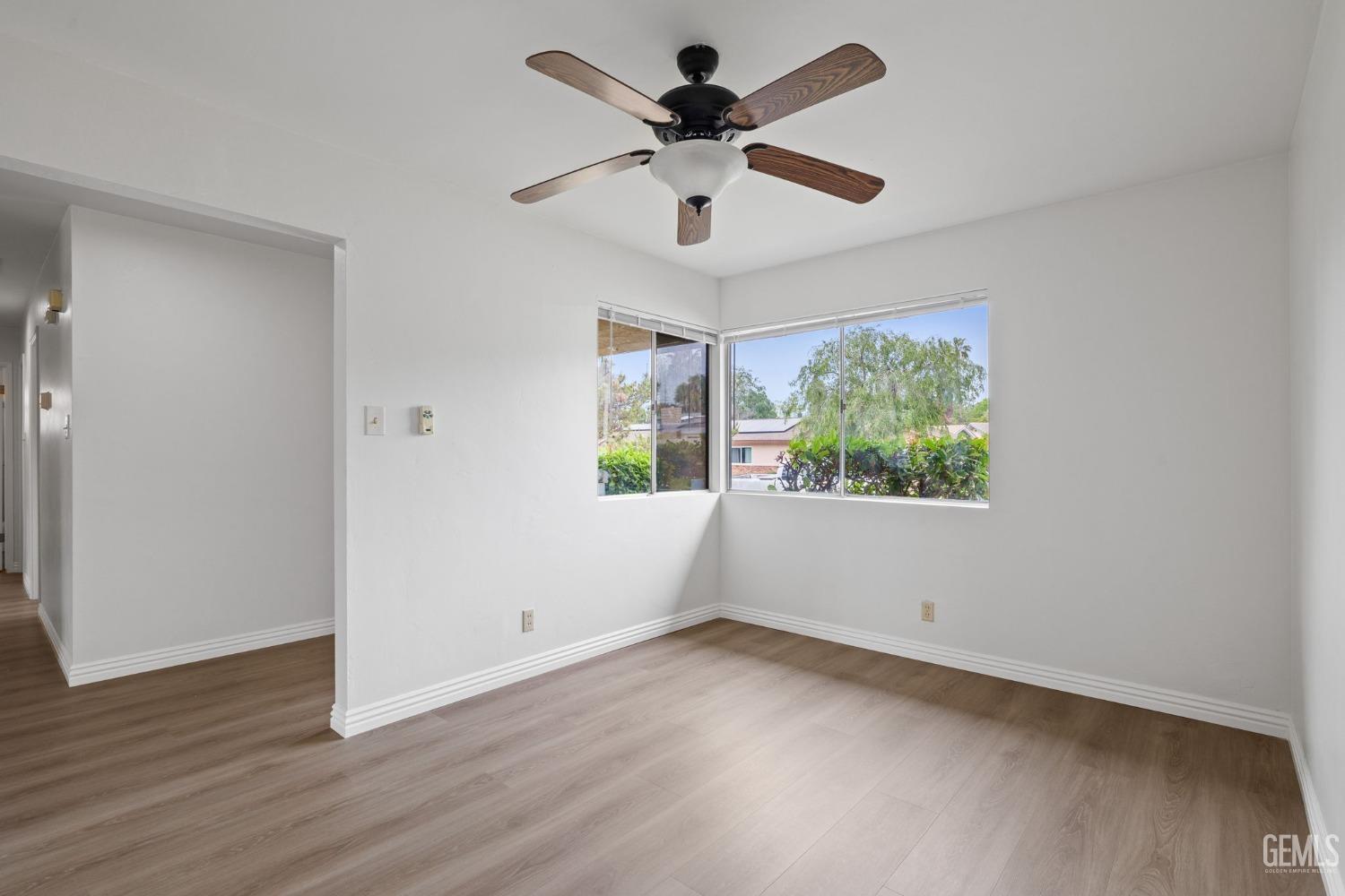 Undisclosed Address Bakersfield, CA 93306 - Photo 12 of 46 a view of an empty room with wooden floor and a window