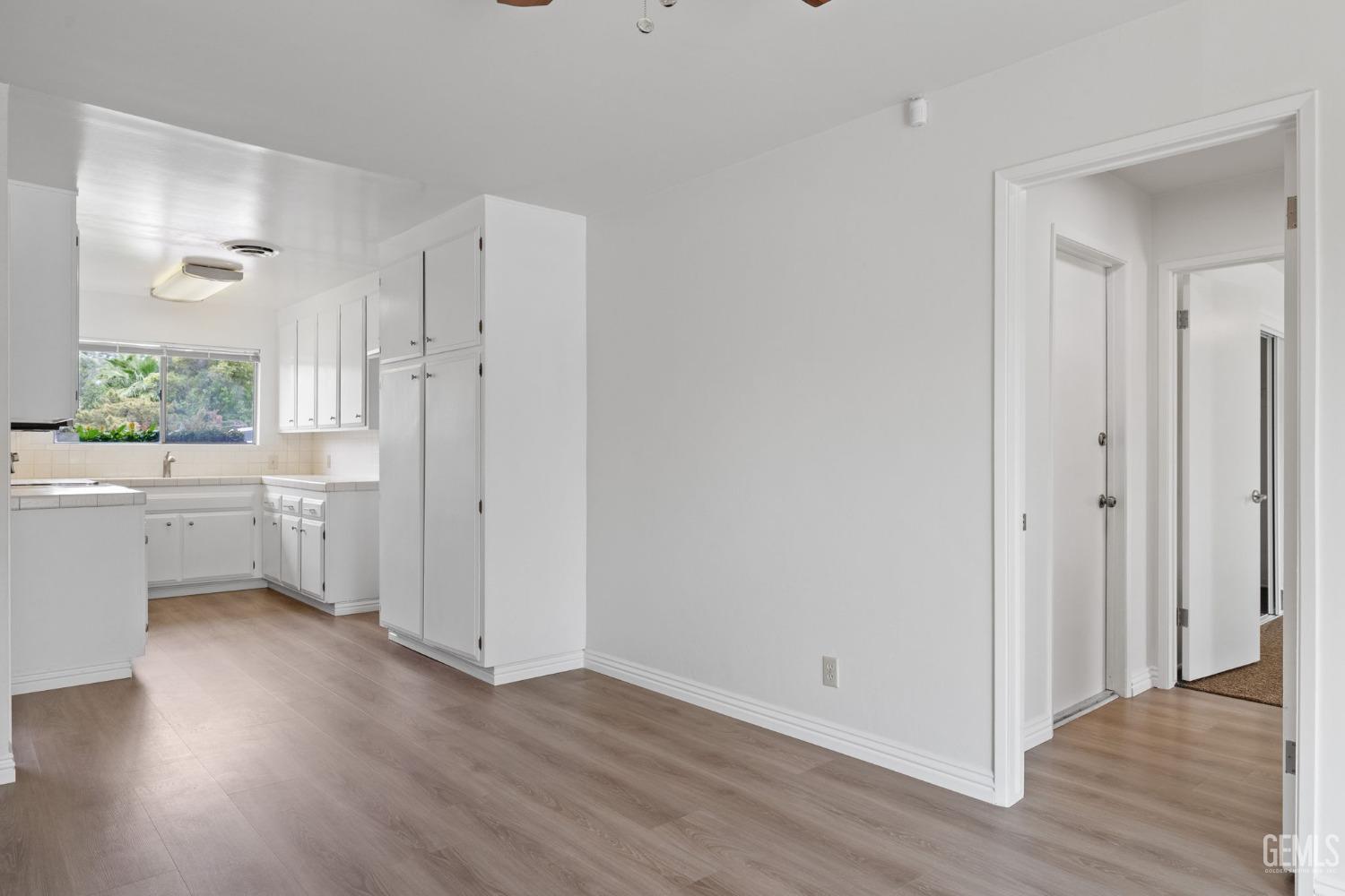 Undisclosed Address Bakersfield, CA 93306 - Photo 15 of 46 a view of a kitchen with wooden floor a sink and a window