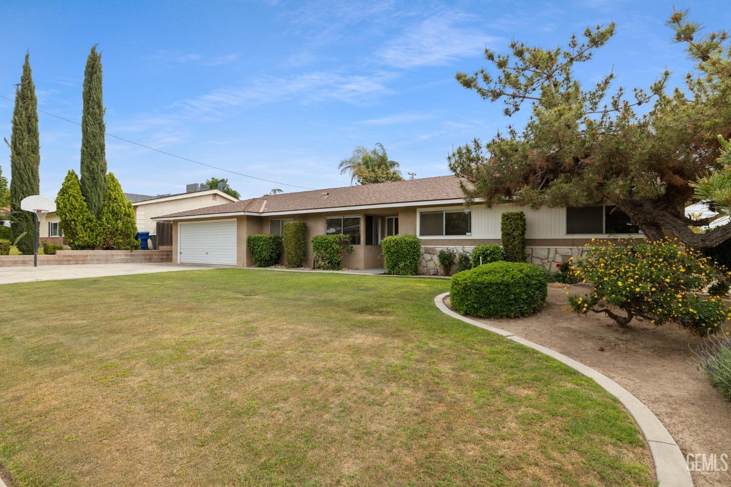 Undisclosed Address Bakersfield, CA 93306 - Photo 2 of 46 a front view of a house with a yard