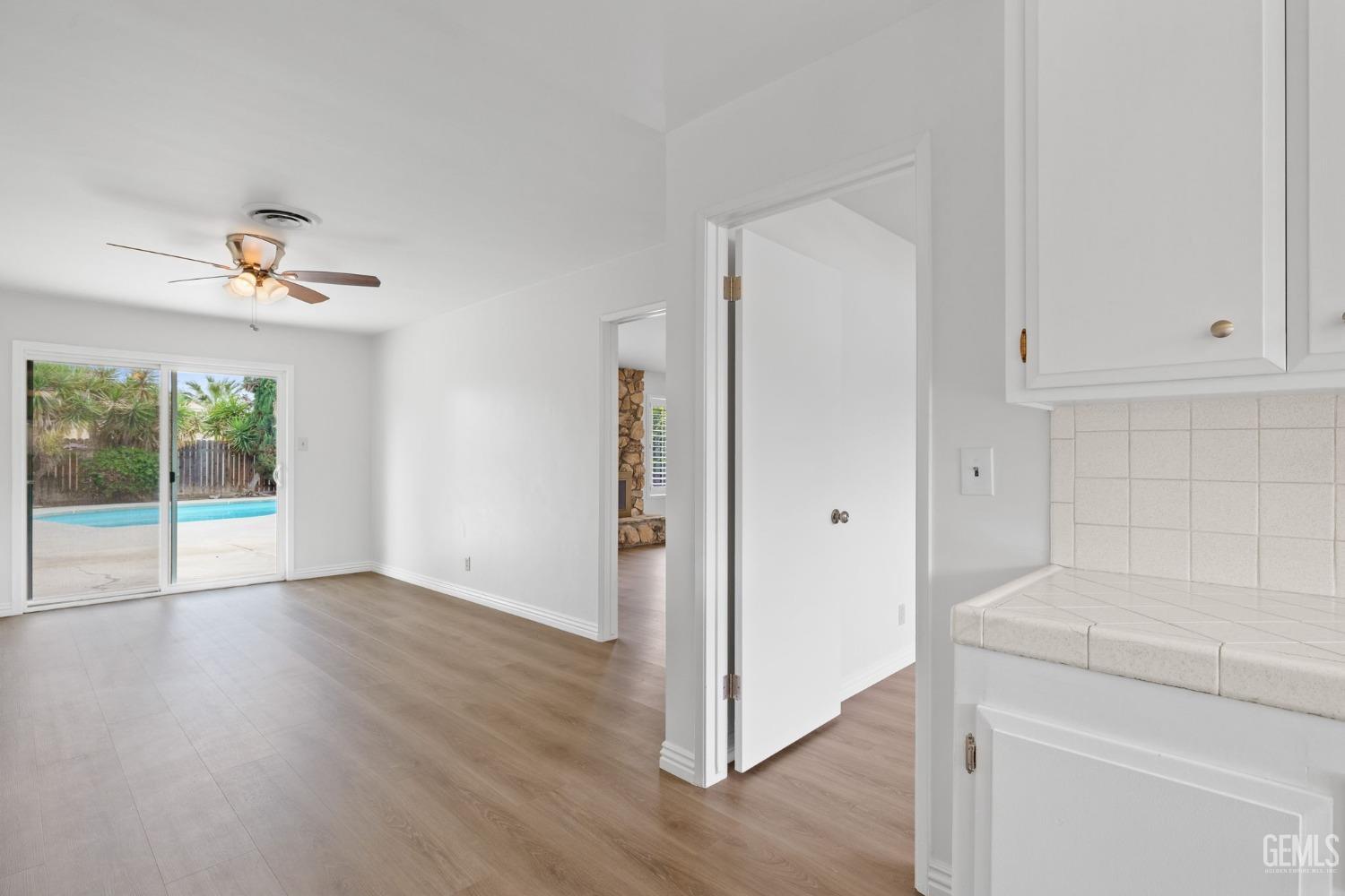 Undisclosed Address Bakersfield, CA 93306 - Photo 21 of 46 a view of an empty room with wooden floor and a window
