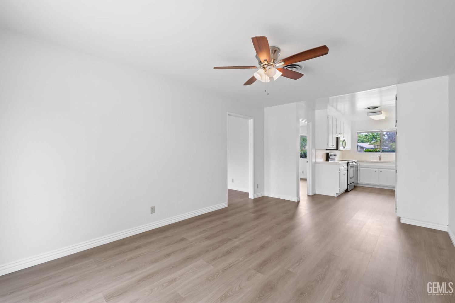 Undisclosed Address Bakersfield, CA 93306 - Photo 23 of 46 a view of a kitchen with a sink and dishwasher a refrigerator with wooden floor