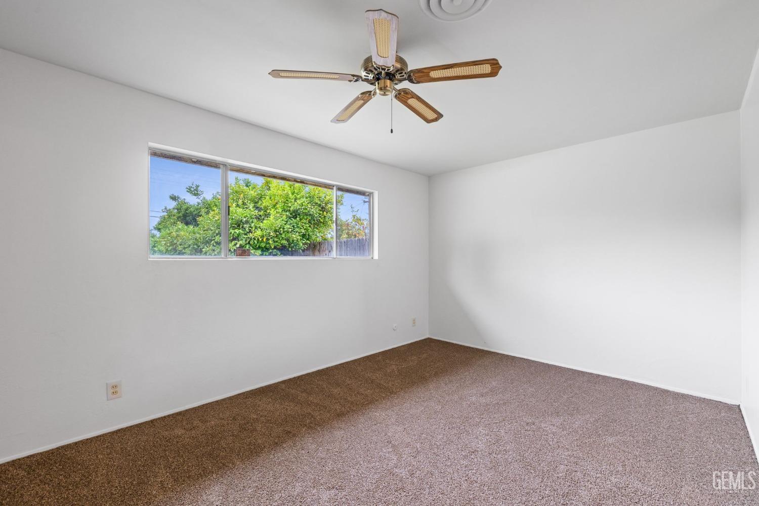 Undisclosed Address Bakersfield, CA 93306 - Photo 29 of 46 an empty room with windows and ceiling fan