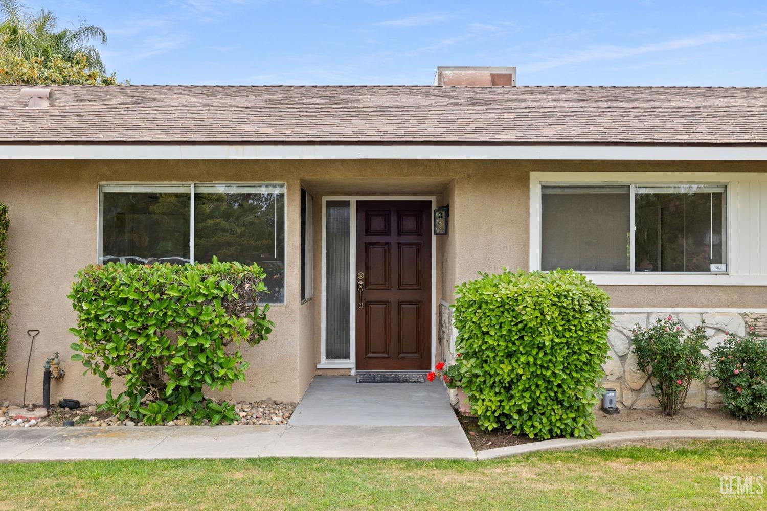 Undisclosed Address Bakersfield, CA 93306 - Photo 3 of 46 a front view of a house with garden