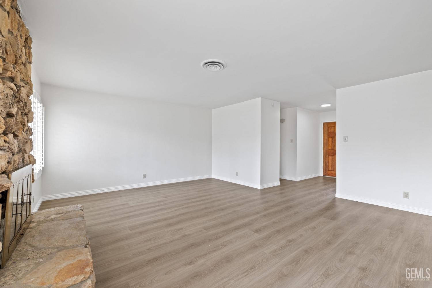 Undisclosed Address Bakersfield, CA 93306 - Photo 7 of 46 a view of an empty room with wooden floor and a window