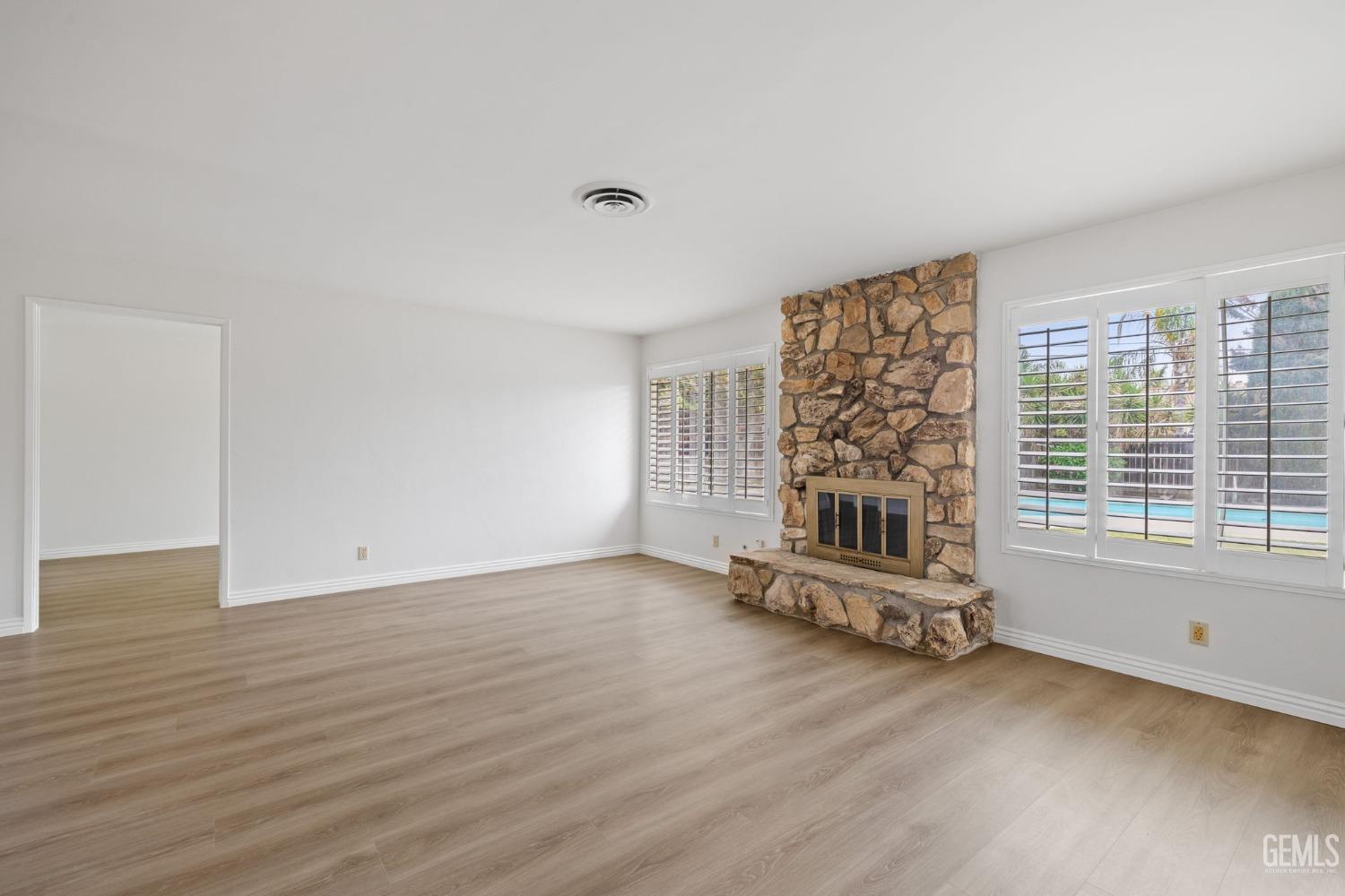 Undisclosed Address Bakersfield, CA 93306 - Photo 8 of 46 an empty room with wooden floor and windows