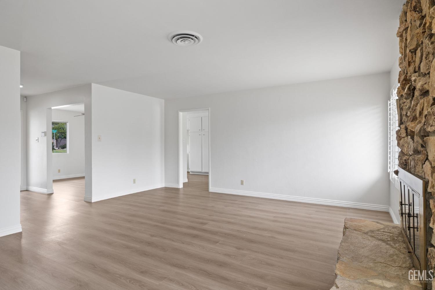 Undisclosed Address Bakersfield, CA 93306 - Photo 9 of 46 a view of an empty room with wooden floor and a window