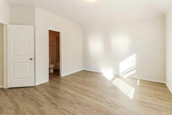 a view of an empty room and wooden floor