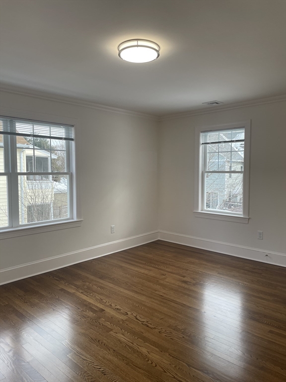 29 Crescent Road, Unit 29 Belmont, MA 02478 - Photo 12 of 21 an empty room with wooden floor and windows