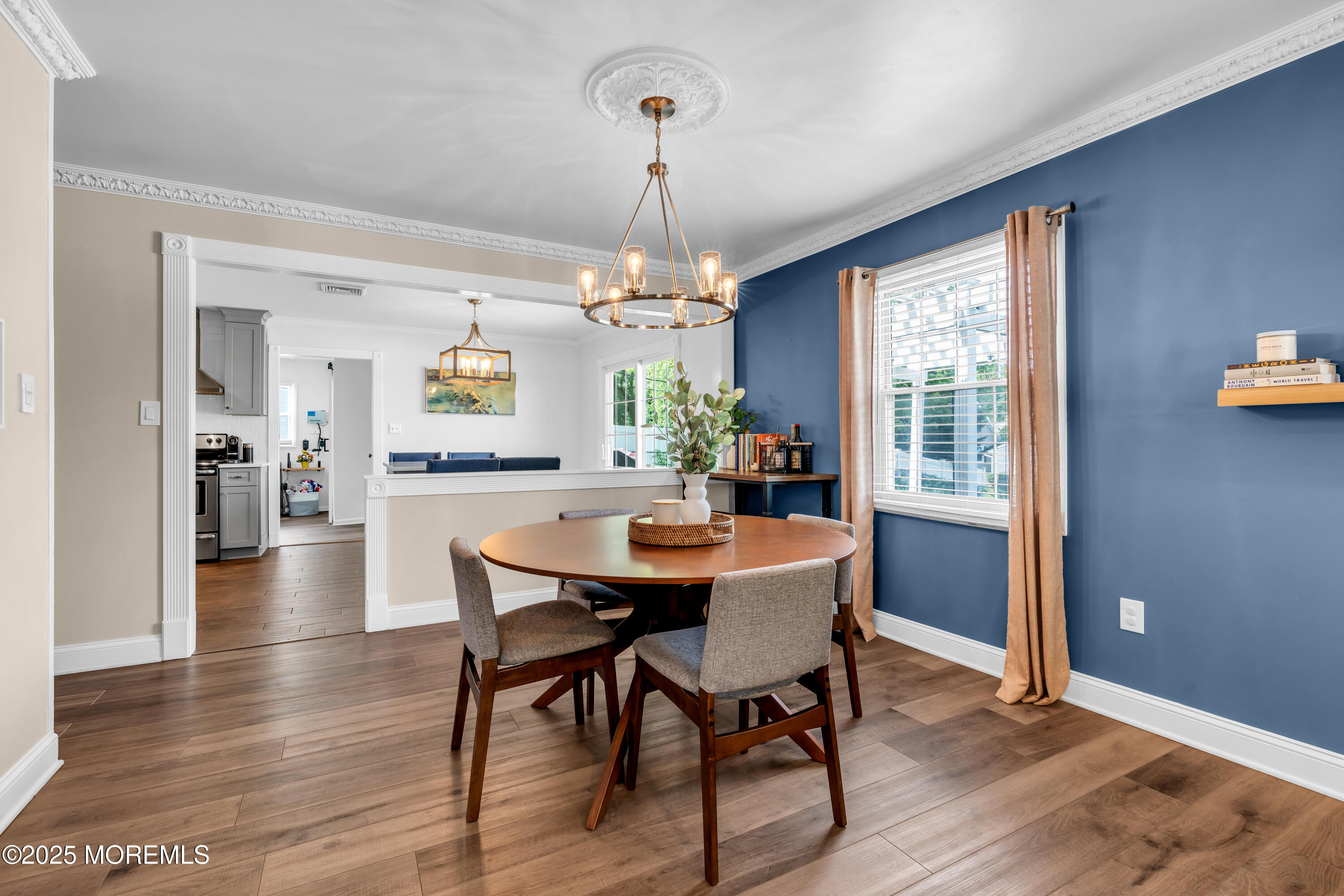511 Line Road Aberdeen, NJ 07747 - Photo 12 of 53 a dining room with wooden floor a chandelier a wooden table and chairs
