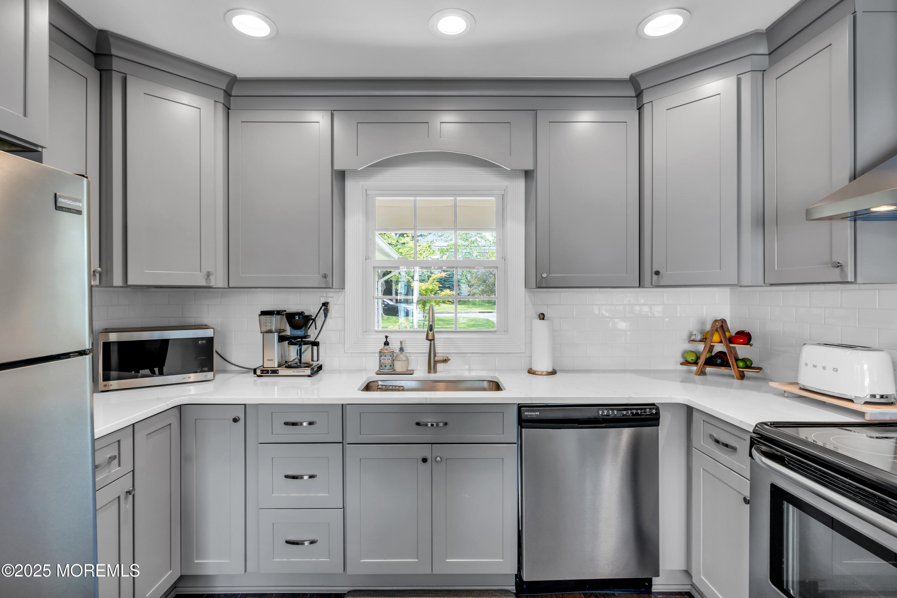 511 Line Road Aberdeen, NJ 07747 - Photo 18 of 53 a kitchen with a sink a stove and cabinets