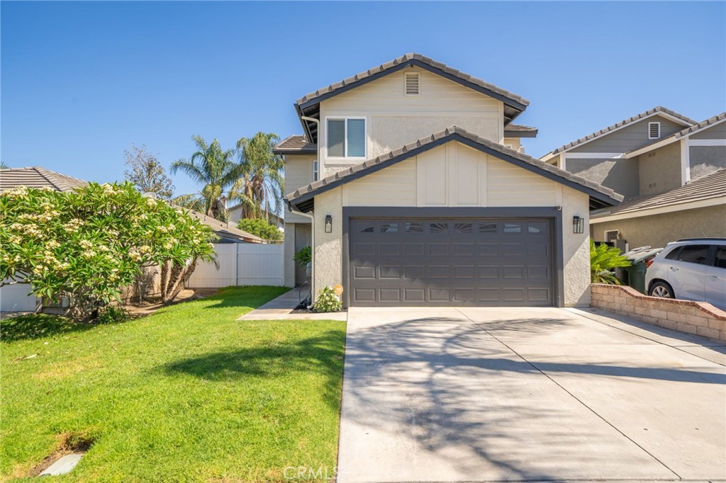2001 Fig Tree Road Colton, CA 92324 - Photo 1 of 1 a front view of a house with a yard and garage