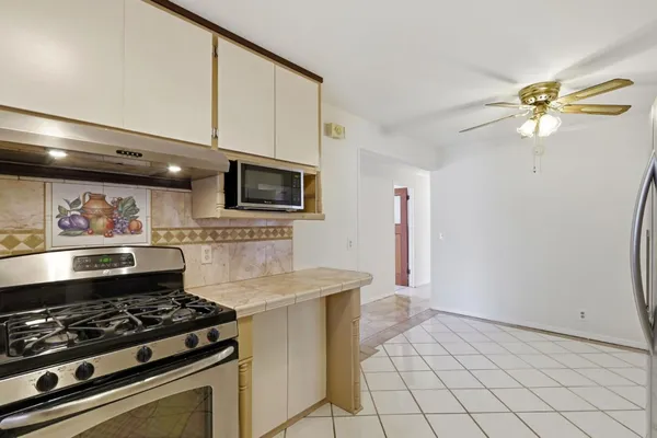 a kitchen with a stove and a refrigerator