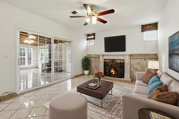 a living room with furniture a flat screen tv and a fireplace