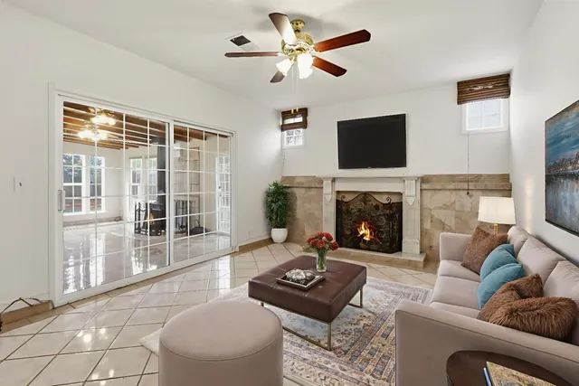 a living room with furniture a flat screen tv and a fireplace