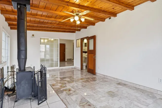 a view of a hallway with furniture and windows