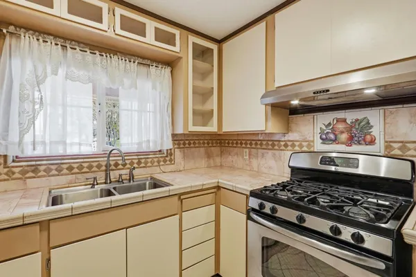a kitchen with a stove and a sink