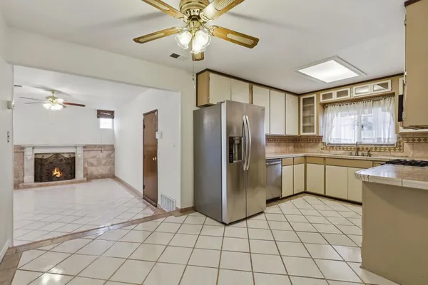a kitchen with a refrigerator a sink and cabinets