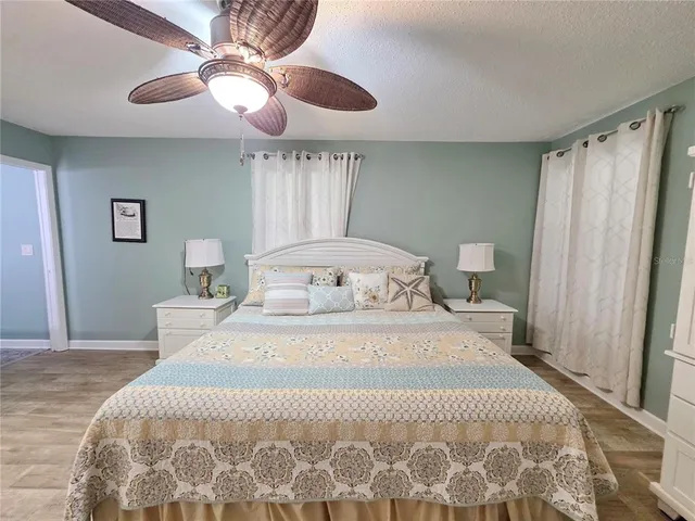 a bedroom with a large bed and a chandelier
