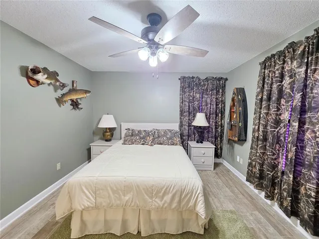 a bedroom with a large bed and a chandelier