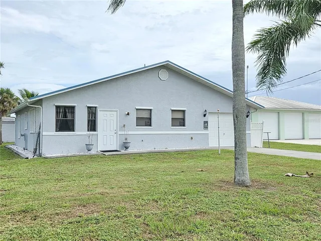 a view of a house with a yard and fence