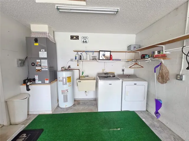 a utility room with cabinets washer and dryer