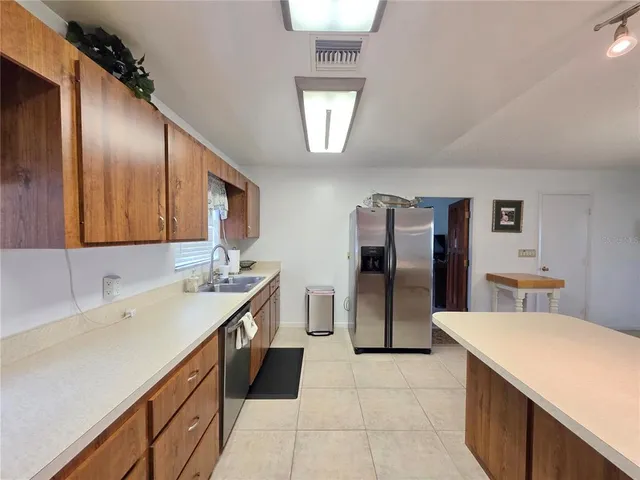a kitchen with stainless steel appliances a sink stove and refrigerator