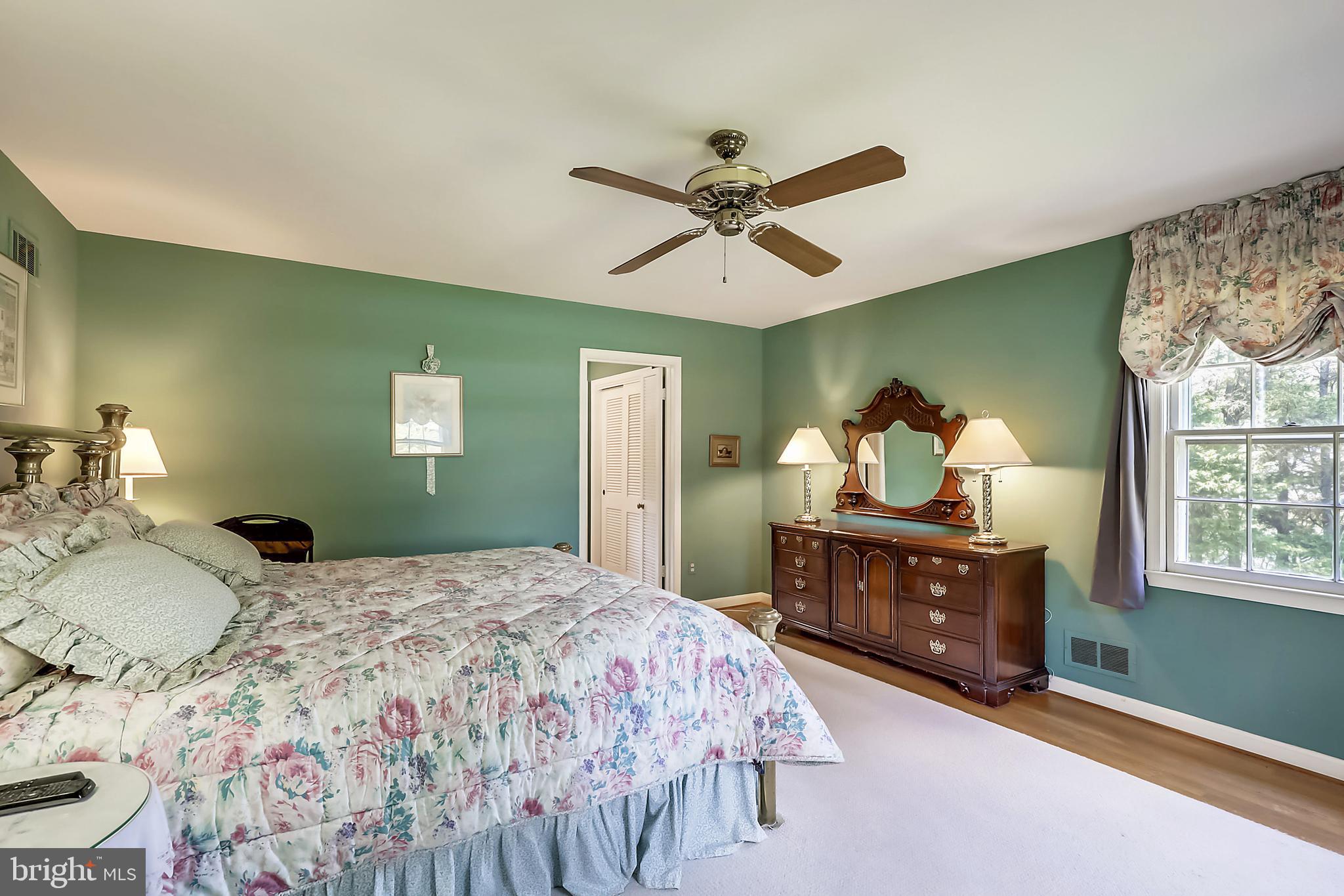 10740 River Road Potomac, MD 20854 - Photo 23 of 64 Ceiling fan and hardwood floors in master bedroom