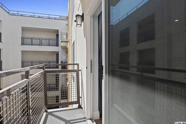a view of a balcony with furniture and a window