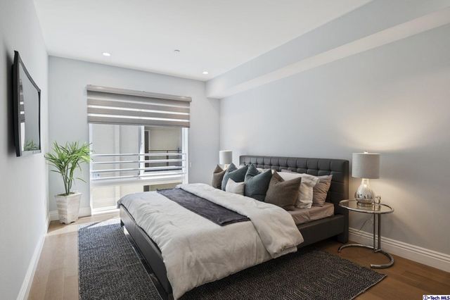 a bedroom with bed and walk in closet