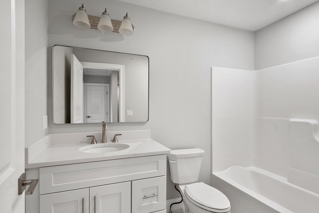 10 Windsor Street Worcester, MA 01605 - Photo 17 of 26 a bathroom with a sink toilet and shower