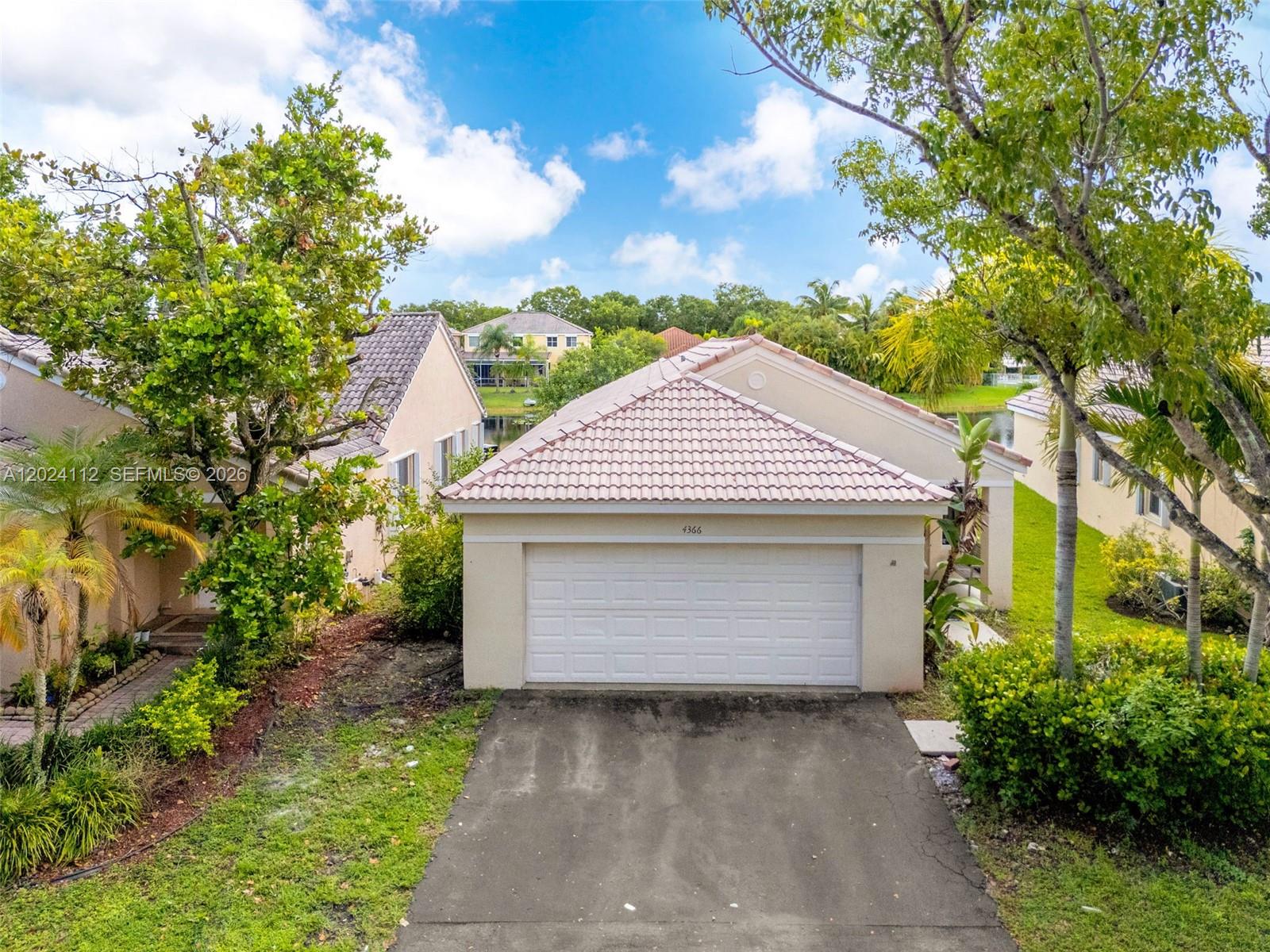 4366 Mahogany Ridge Drive Weston, FL 33331 - Photo 34 of 41 a front view of a house with a garden