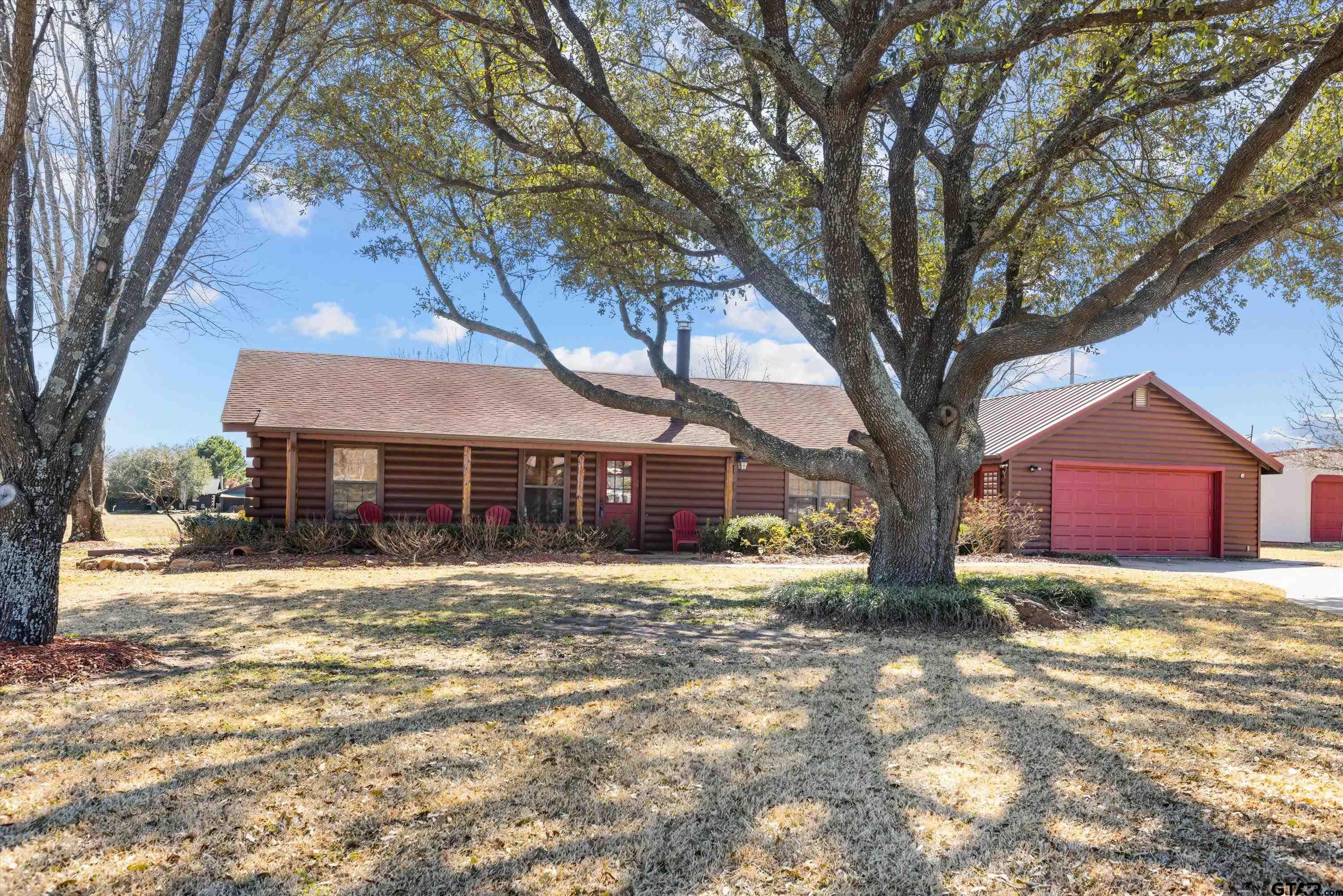 129 Private Road 5569 Alba, TX 75410 - Photo 1 of 40 a white house that has a tree in front of it
