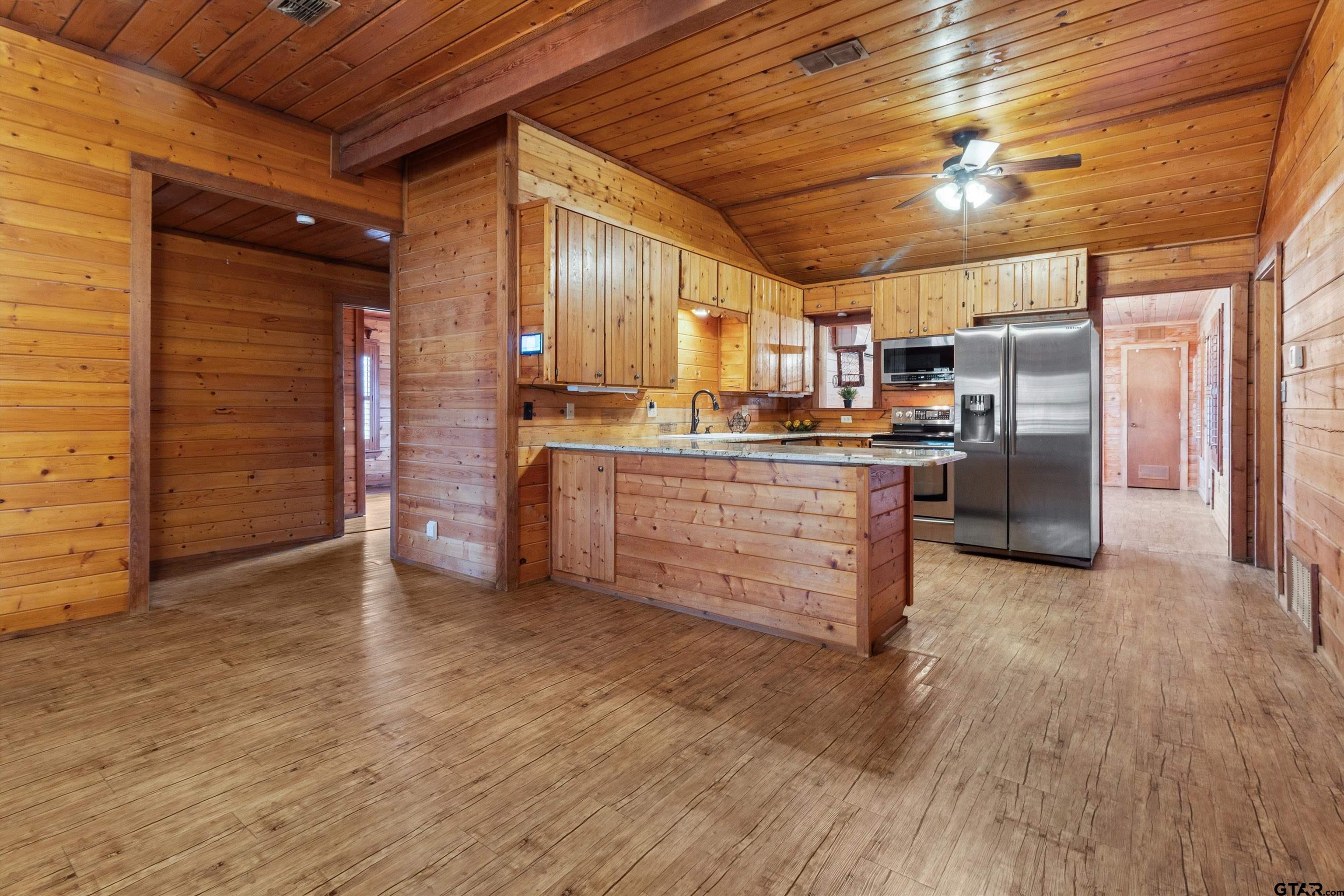 129 Private Road 5569 Alba, TX 75410 - Photo 11 of 40 a kitchen with stainless steel appliances granite countertop a stove and a refrigerator