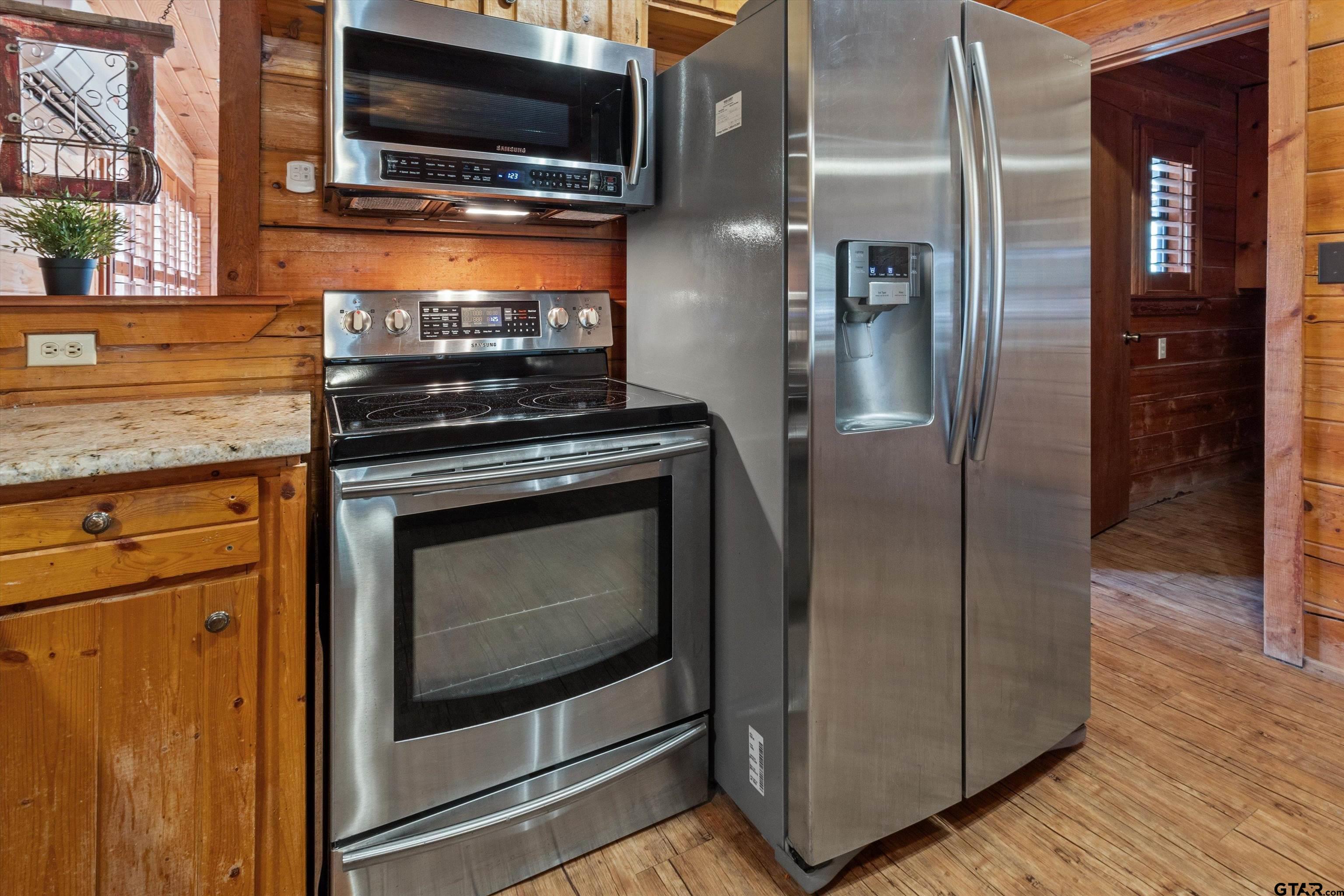 129 Private Road 5569 Alba, TX 75410 - Photo 12 of 40 a kitchen with stainless steel appliances granite countertop a stove microwave and refrigerator