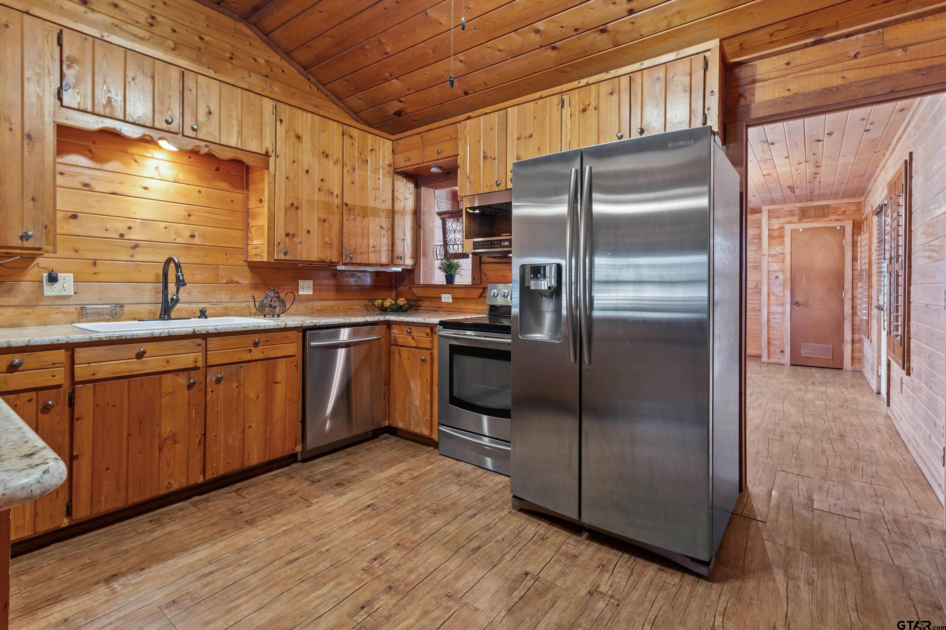 129 Private Road 5569 Alba, TX 75410 - Photo 13 of 40 a kitchen with stainless steel appliances cabinets a sink and a refrigerator