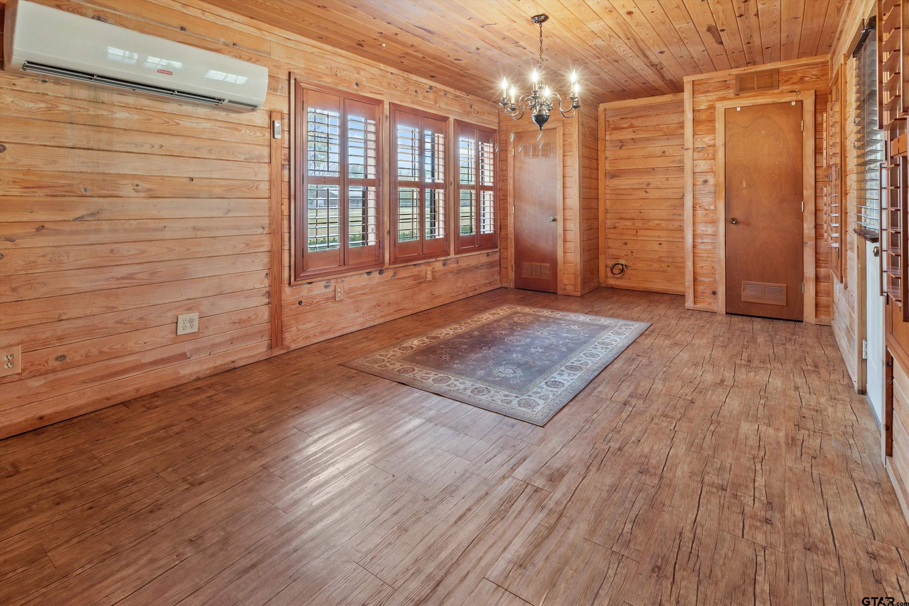 129 Private Road 5569 Alba, TX 75410 - Photo 14 of 40 a view of an empty room with wooden floor and a window
