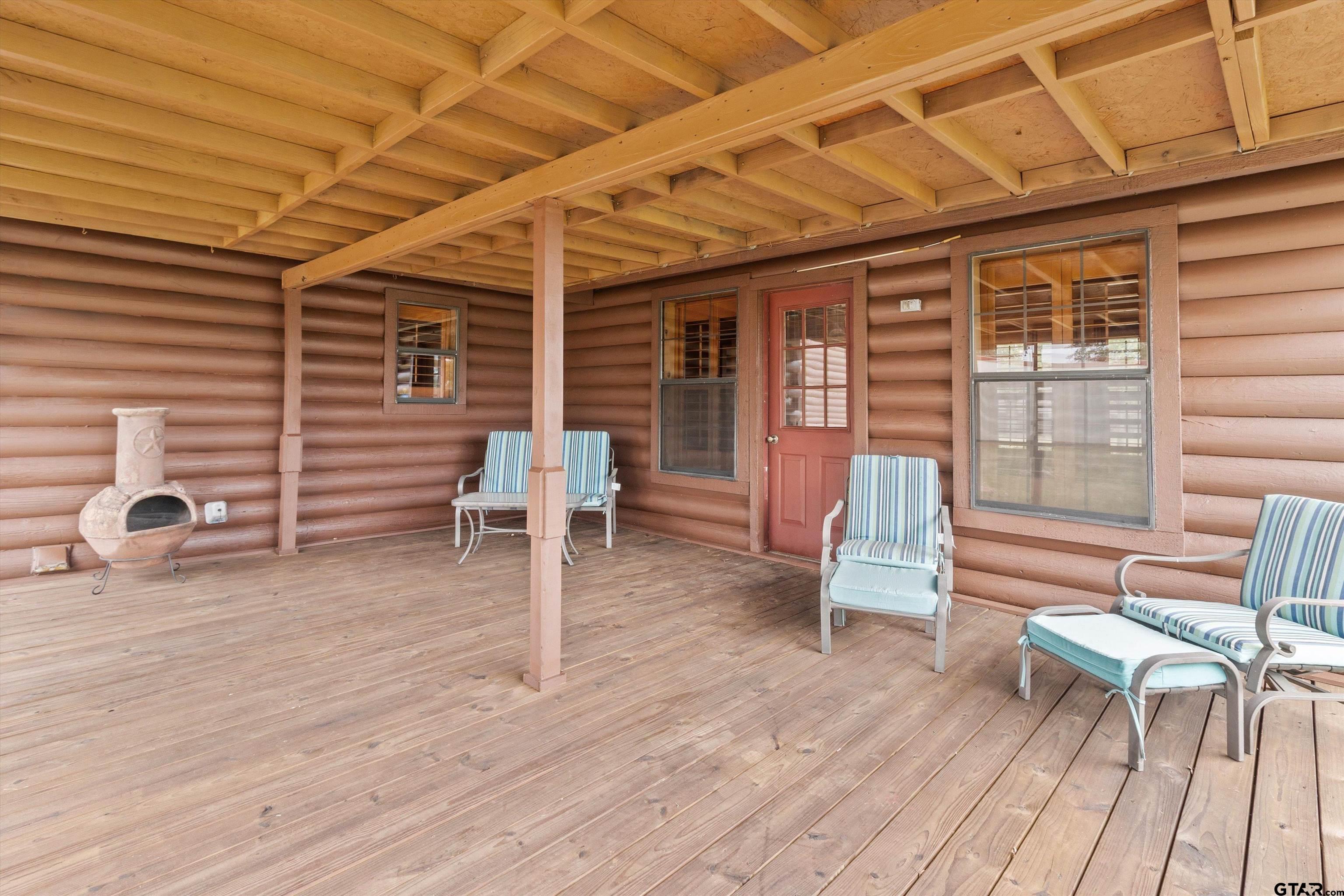 129 Private Road 5569 Alba, TX 75410 - Photo 21 of 40 a balcony with furniture and wooden floor