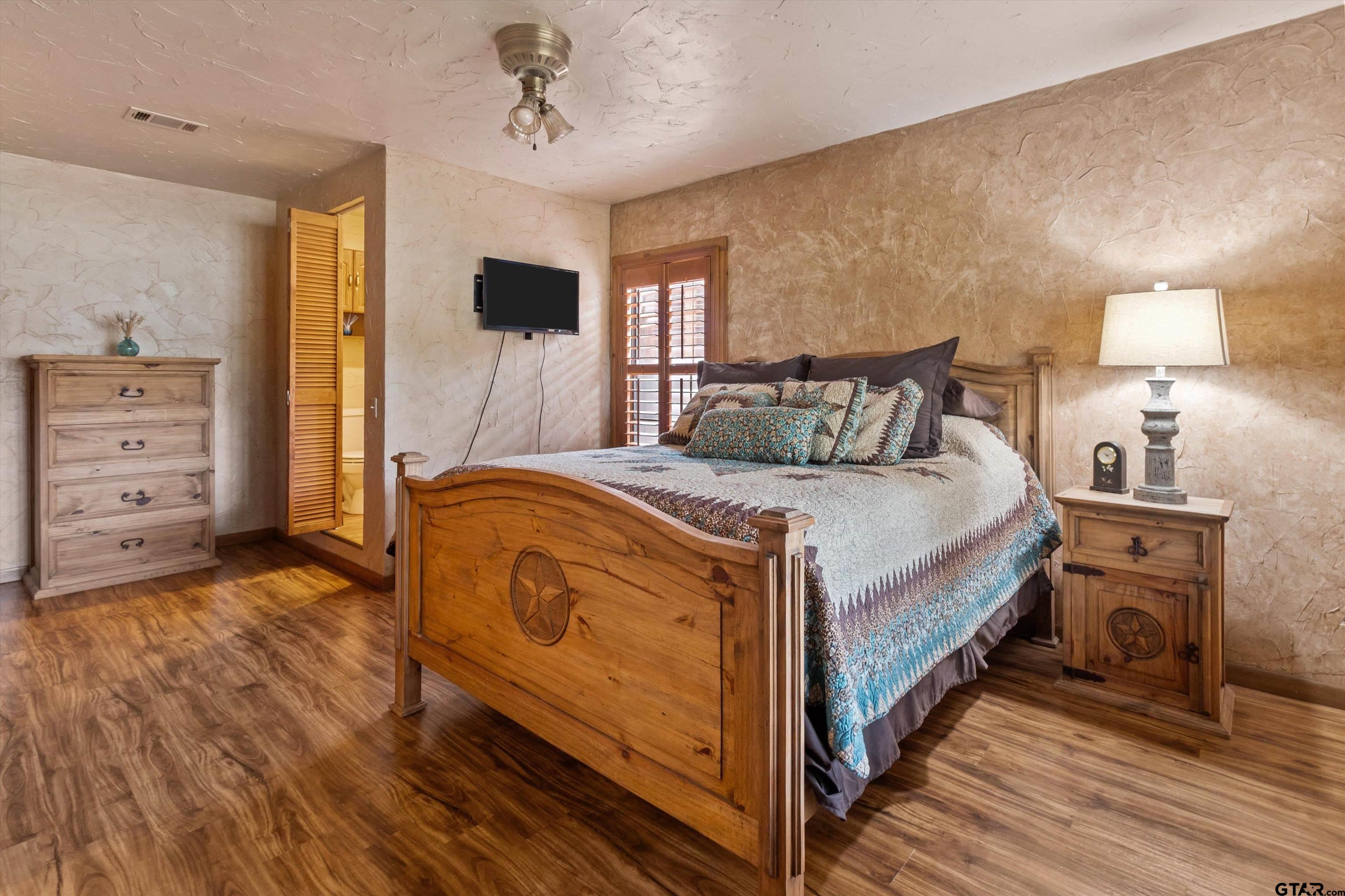 129 Private Road 5569 Alba, TX 75410 - Photo 23 of 40 a bed room with a bed tv and a chair