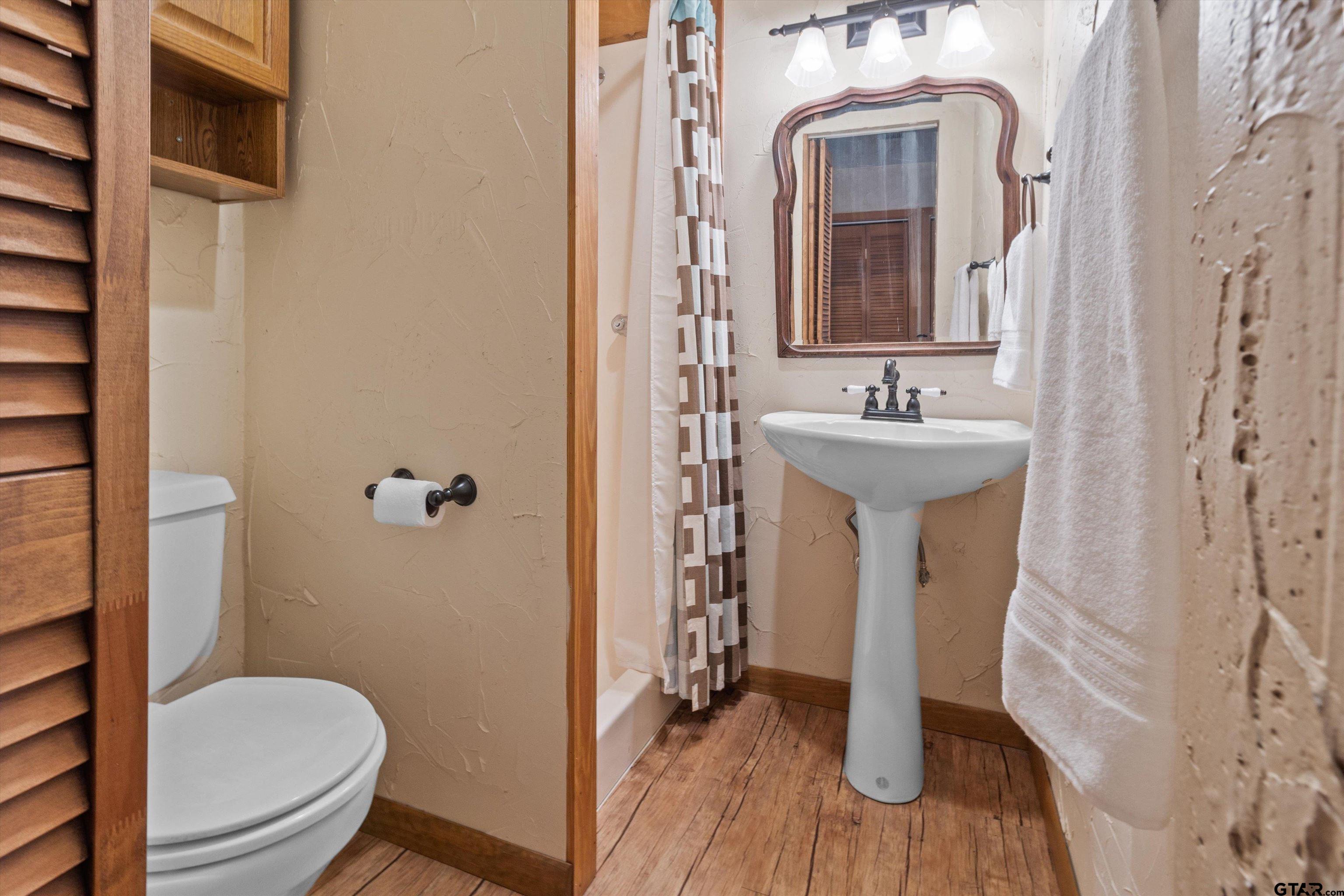 129 Private Road 5569 Alba, TX 75410 - Photo 24 of 40 a bathroom with a toilet a sink and mirror