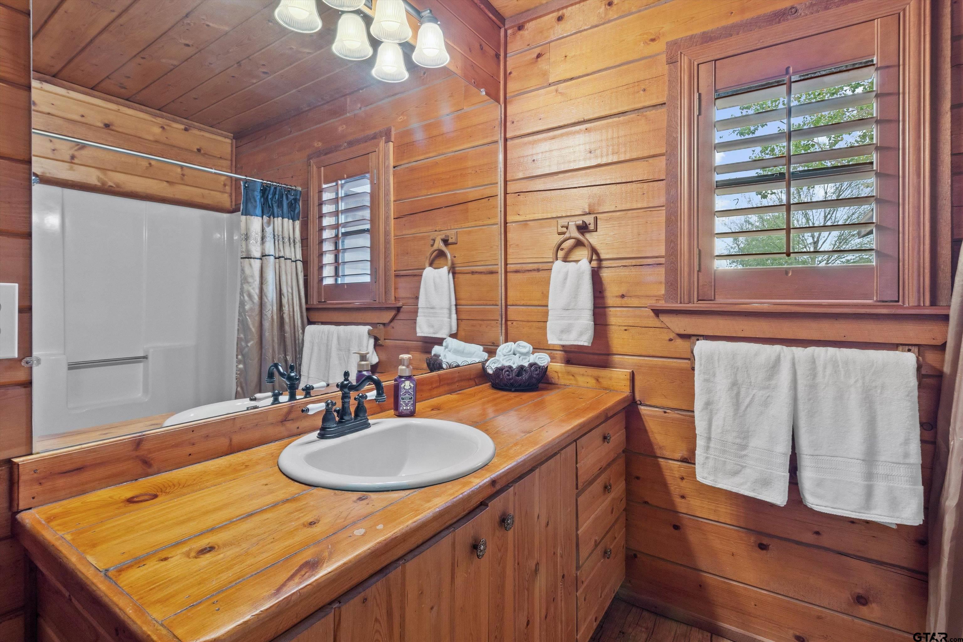 129 Private Road 5569 Alba, TX 75410 - Photo 32 of 40 a bathroom with a sink double vanity and a mirror