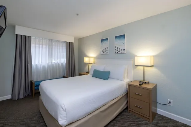 a bedroom with a bed and a lamp