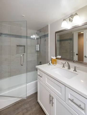 a kitchen with stainless steel appliances granite countertop a sink a stove a microwave a refrigerator and cabinets